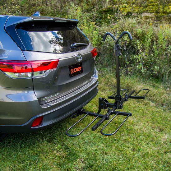 CURT Tray-Style Bike Rack with Three-Point Support System CURT tray-style bike rack securely holding two bicycles with a unique three-point support system