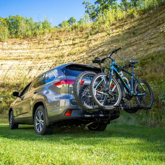 CURT Tray-Style Bike Rack with Three-Point Support System CURT tray-style bike rack securely holding two bicycles with a unique three-point support system