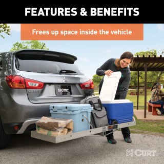 CURT Aluminum Hitch-Mounted Folding Cargo Carrier 500 lbs Capacity CURT tray-style hitch-mounted cargo carrier with aluminum design, folding feature, and 500 lbs capacity mounted on a vehicle.