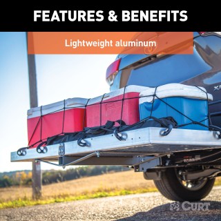 CURT Aluminum Hitch-Mounted Folding Cargo Carrier 500 lbs Capacity CURT tray-style hitch-mounted cargo carrier with aluminum design, folding feature, and 500 lbs capacity mounted on a vehicle.