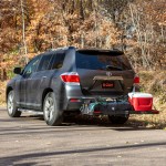 CURT trailer hitch cargo carrier, mesh tray-style, black powder coat, mounted on vehicle.