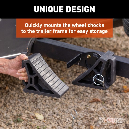 CURT HD Wheel Chocks with Mounting Bracket for Trailers CURT HD wheel chocks mounted on trailer frame with orange finish