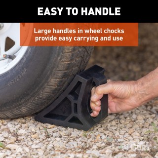 CURT HD Wheel Chocks with Mounting Bracket for Trailers CURT HD wheel chocks mounted on trailer frame with orange finish