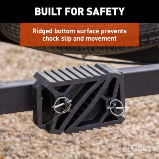 CURT HD Wheel Chocks with Mounting Bracket for Trailers CURT HD wheel chocks mounted on trailer frame with orange finish