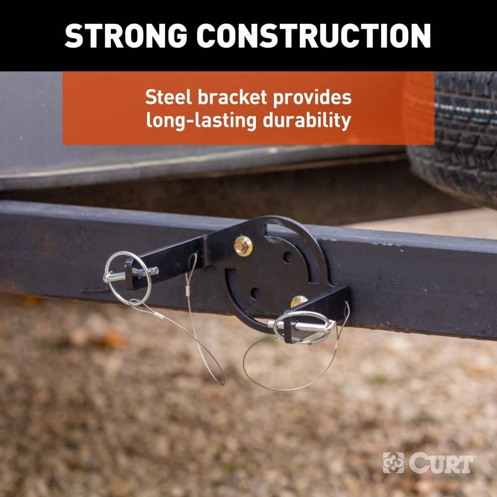 CURT HD Wheel Chocks with Mounting Bracket for Trailers CURT HD wheel chocks mounted on trailer frame with orange finish