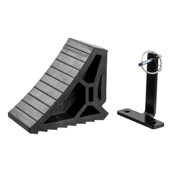 CURT HD Wheel Chocks with Mounting Bracket for Easy Storage CURT HD wheel chocks with mounting bracket attached to trailer, shown in use.