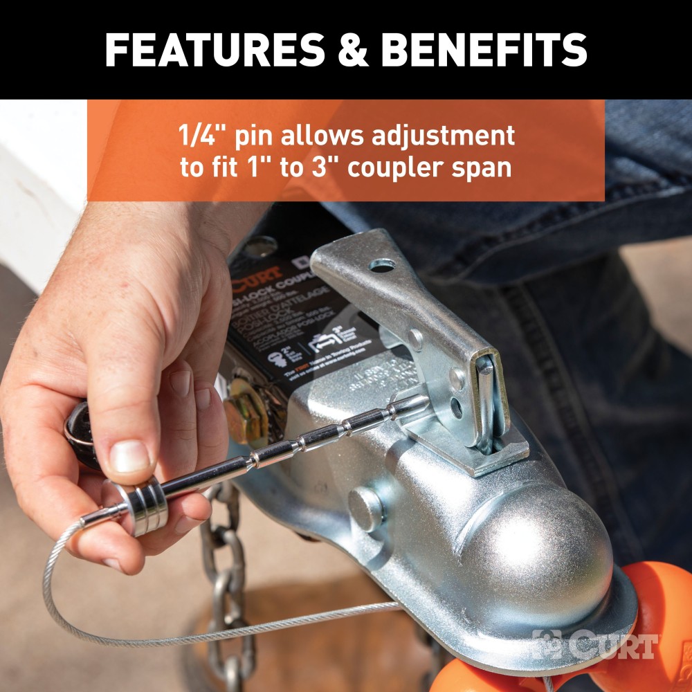CURT tri-ball universal coupler lock in orange, securely attached to a trailer hitch