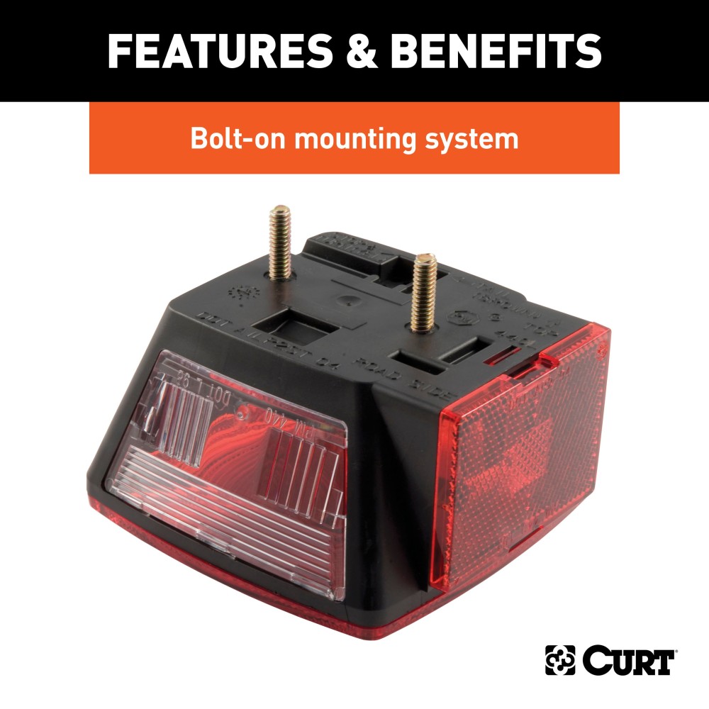 Driver-side CURT trailer taillight featuring molded housing and red lenses, including license plate illuminator and extra connections.