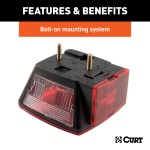 Driver-side CURT trailer taillight featuring molded housing and red lenses, including license plate illuminator and extra connections.