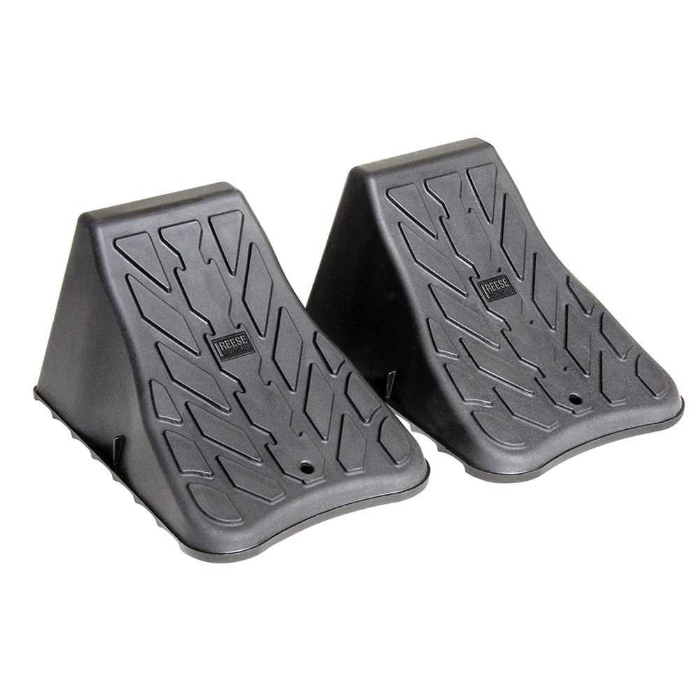 High Impact Polymer Trailer Wheel Chocks for Stability A pair of high impact polymer wheel chocks placed under trailer tires.
