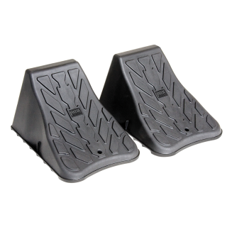 High Impact Polymer Trailer Wheel Chocks for Stability A pair of high impact polymer wheel chocks placed under trailer tires.