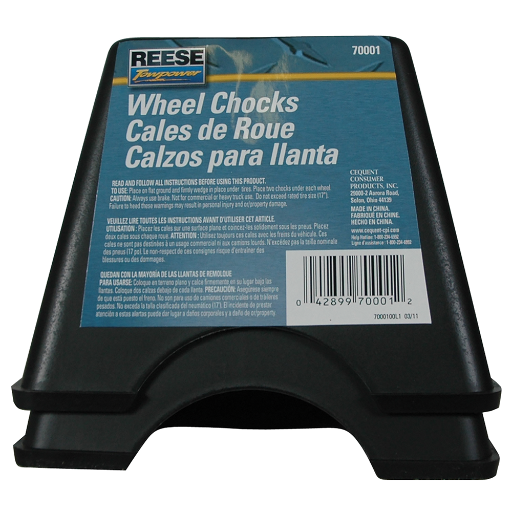High Impact Polymer Trailer Wheel Chocks for Stability A pair of high impact polymer wheel chocks placed under trailer tires.