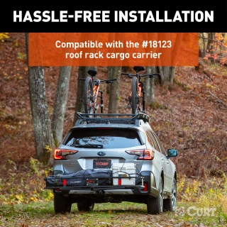 CURT quick-release bike mount attached to a roof rack holding bicycles