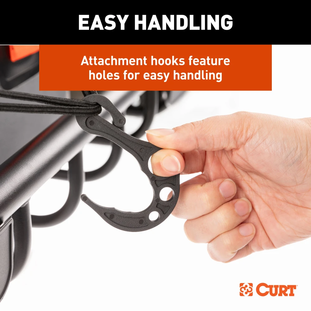 CURT cargo carrier net securely fastened over roof rack with hooks