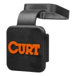 CURT trailer hitch cover made from black rubber, protects 2-inch receiver tube with orange logo and friction fit design.