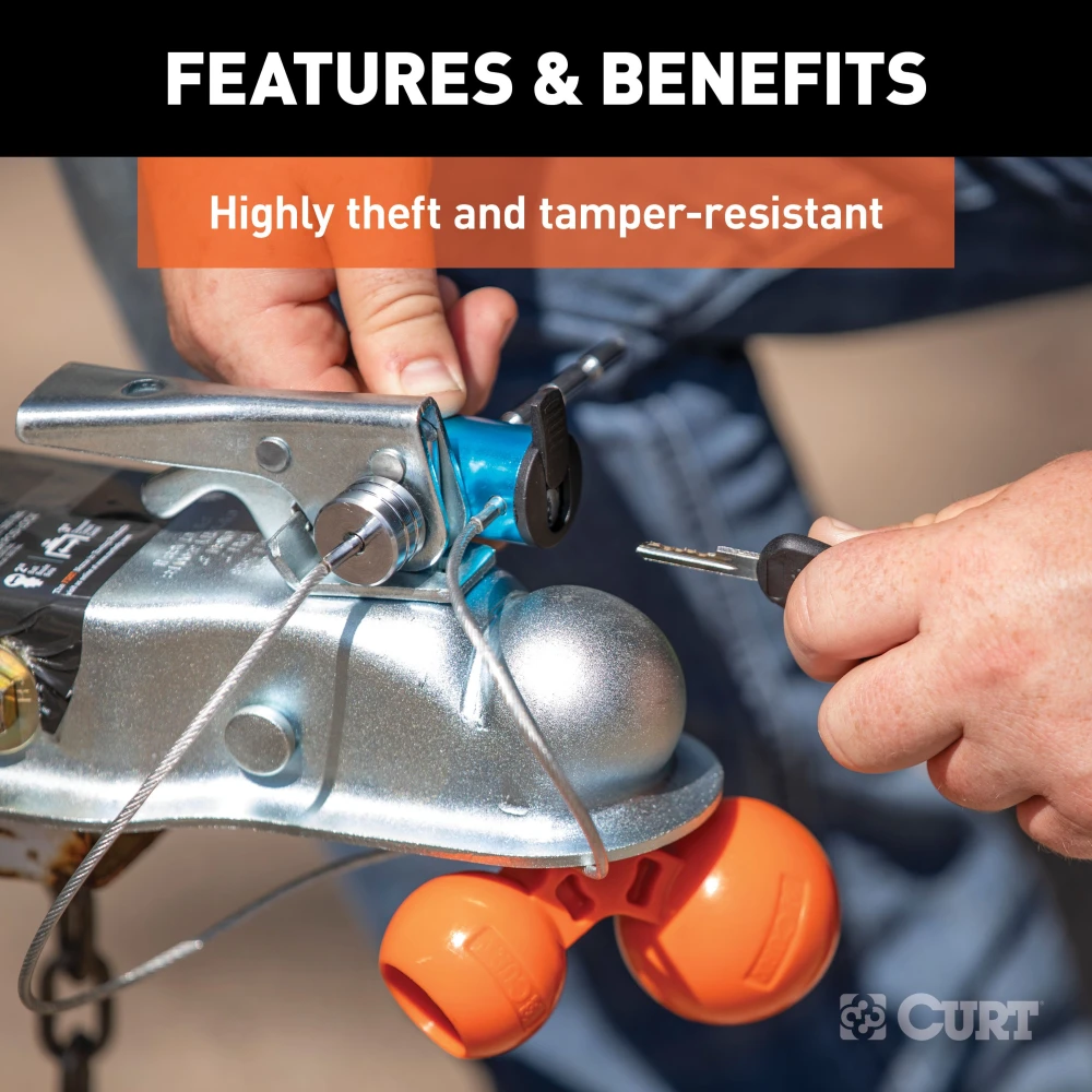 CURT tri-ball universal coupler lock in orange, securely attached to a trailer hitch