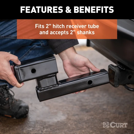 CURT hitch adapter for towing with 4-inch rise or drop, fits 2-inch receiver, black finish.