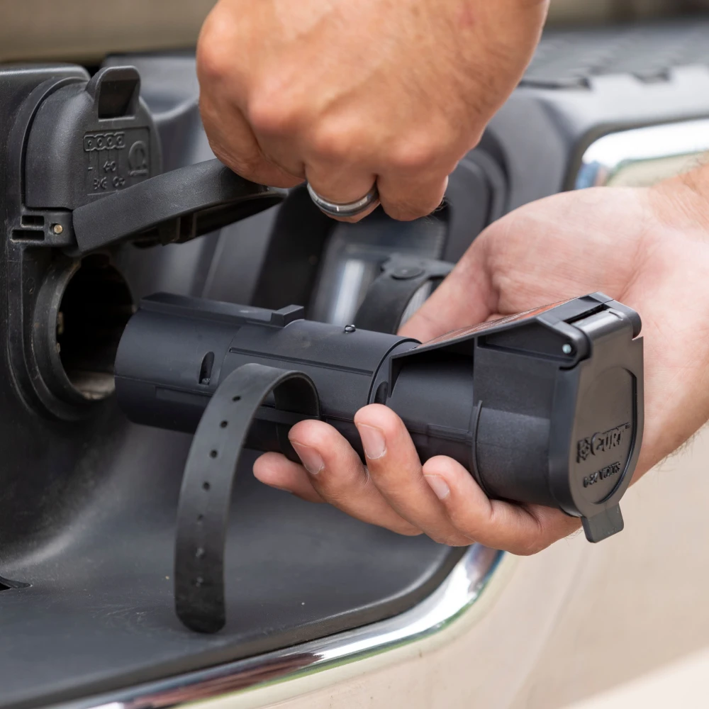 CURT Echo mobile trailer brake controller connected to a smartphone for wireless control