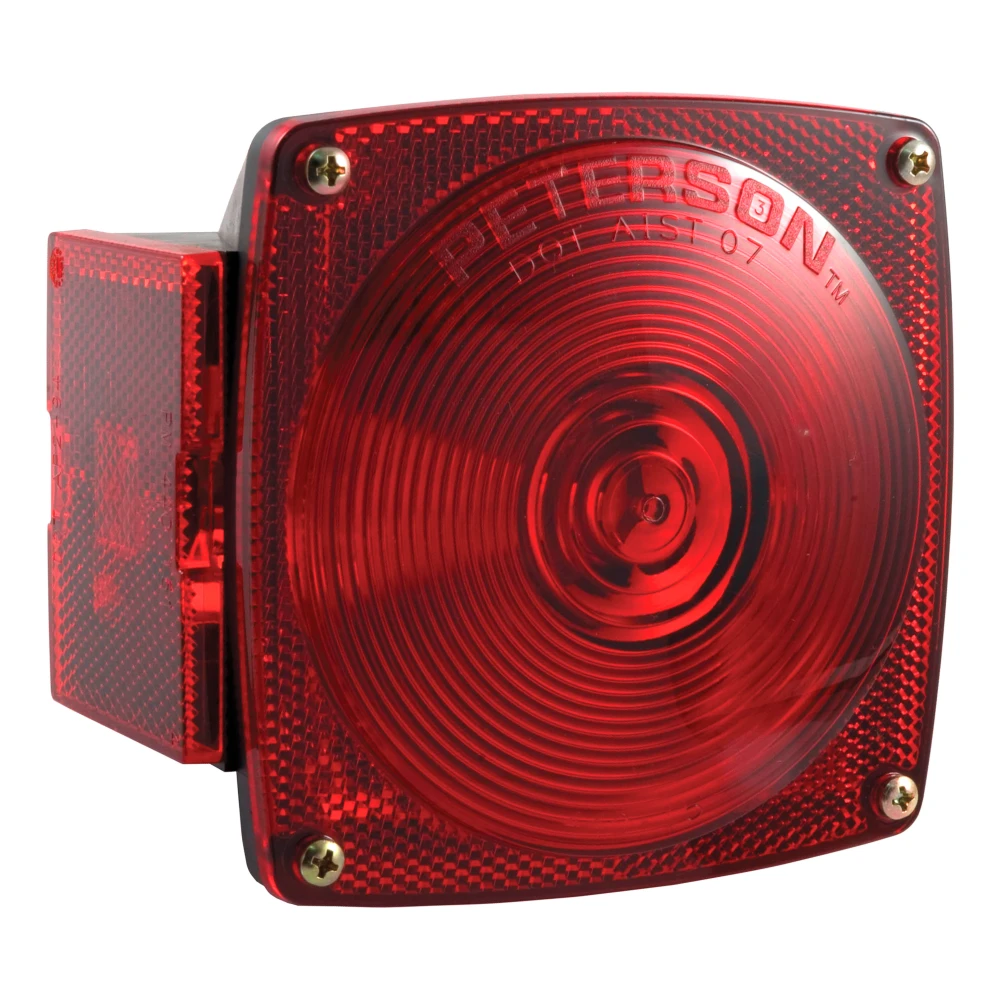 Driver-side CURT trailer taillight featuring molded housing and red lenses, including license plate illuminator and extra connections.