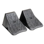 High Impact Polymer Trailer Wheel Chocks for Stability A pair of high impact polymer wheel chocks placed under trailer tires.