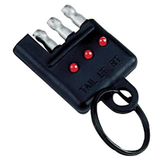 REESE Towpower electrical circuit tester connected to a vehicle's 4-flat connector.